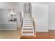 Elegant staircase featuring wood treads, decorative iron railings, and neutral wall color at 302 Red Elm Dr, Durham, NC 27713