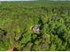 Stunning aerial view of a secluded home surrounded by lush green forest at 3035 Tavistock Dr, Durham, NC 27712