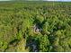 A high aerial view of the home, surrounded by mature trees at 3035 Tavistock Dr, Durham, NC 27712