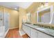 Bathroom featuring double sinks, granite countertops, wood flooring and a glass shower at 3035 Tavistock Dr, Durham, NC 27712