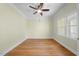 Neutral bedroom featuring hardwood floors, a ceiling fan, white trim and one window at 3035 Tavistock Dr, Durham, NC 27712