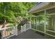 Back deck with railings overlooks a beautifully landscaped yard and mature trees at 3035 Tavistock Dr, Durham, NC 27712