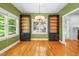 Dining room features hardwood floors, built in shelving units, a ceiling fan, and natural light at 3035 Tavistock Dr, Durham, NC 27712