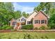 Inviting home with a charming front porch and well-maintained landscaping at 3035 Tavistock Dr, Durham, NC 27712