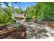 Charming two-story yellow home with well-manicured landscaping and an attached garage at 3035 Tavistock Dr, Durham, NC 27712
