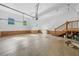 Spacious three-car garage features storage shelves, staircase and plenty of parking space at 3035 Tavistock Dr, Durham, NC 27712