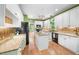 Modern kitchen with white cabinets, granite countertops, and hardwood floors at 3035 Tavistock Dr, Durham, NC 27712