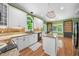 Well-appointed kitchen featuring white cabinetry, granite countertops, and stainless steel appliances at 3035 Tavistock Dr, Durham, NC 27712
