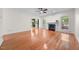 Bright living room with hardwood floors, fireplace, and open access to other spaces at 3035 Tavistock Dr, Durham, NC 27712