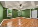 Spacious main bedroom featuring hardwood floors, a ceiling fan, neutral colors and natural light at 3035 Tavistock Dr, Durham, NC 27712