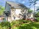 Beautiful back exterior with mature landscaping, a wooden deck, and a lush green lawn at 3204 Terrel Mill Rd, Raleigh, NC 27616