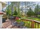 Backyard deck with metal table and chairs surrounded by trees and lush green grass at 3204 Terrel Mill Rd, Raleigh, NC 27616