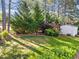 Serene backyard featuring lush greenery and shade trees, with a storage shed in the background at 3204 Terrel Mill Rd, Raleigh, NC 27616