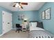 Bright bedroom with blue walls, a window with natural light, a desk, and comfortable bed at 3204 Terrel Mill Rd, Raleigh, NC 27616