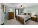 This bedroom features green walls, a ceiling fan and a comfy bed, creating a relaxing retreat at 3204 Terrel Mill Rd, Raleigh, NC 27616