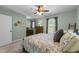Cozy bedroom with soft green walls, carpet, and a comfortable floral patterned bed at 3204 Terrel Mill Rd, Raleigh, NC 27616