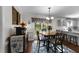 Dining area featuring a table with chairs, buffet table, and natural light from the outdoor patio at 3204 Terrel Mill Rd, Raleigh, NC 27616
