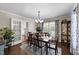 Formal dining room with hardwood floors, elegant chandelier, and natural light at 3204 Terrel Mill Rd, Raleigh, NC 27616