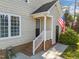 Side entrance features brick steps, white railings and an American flag at 3204 Terrel Mill Rd, Raleigh, NC 27616