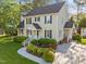 Beautiful two-story home featuring manicured landscaping and mature trees enhancing its curb appeal at 3204 Terrel Mill Rd, Raleigh, NC 27616