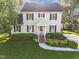 Charming two-story home with a well-manicured lawn and lush landscaping enhancing its curb appeal at 3204 Terrel Mill Rd, Raleigh, NC 27616