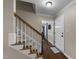 Hallway with carpeted stairs, hardwood floors, and white trim at 3204 Terrel Mill Rd, Raleigh, NC 27616