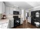 Corner kitchen with stainless steel appliances, a stylish black refrigerator, and dark hardwood flooring at 3204 Terrel Mill Rd, Raleigh, NC 27616