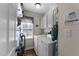 Functional laundry room with white washer and dryer, cabinets, and natural light at 3204 Terrel Mill Rd, Raleigh, NC 27616
