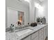 Bathroom features a double sink vanity with modern fixtures and a large mirror at 321 Everly Mist Way, Wake Forest, NC 27587