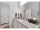 Bright bathroom with granite counters, white cabinetry, and a large mirror creating an open space at 321 Everly Mist Way, Wake Forest, NC 27587