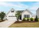 Charming single-story home with white siding, a two-car garage, and well-manicured landscaping at 321 Everly Mist Way, Wake Forest, NC 27587