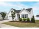 Attractive one-story home with white siding, neat landscaping, and a driveway at 321 Everly Mist Way, Wake Forest, NC 27587