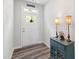 Inviting foyer featuring a stylish console table, lamps, and a view of the front door at 321 Everly Mist Way, Wake Forest, NC 27587