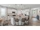 Open concept kitchen with a central island, modern lighting, and a seamless connection to the living area at 321 Everly Mist Way, Wake Forest, NC 27587