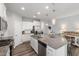 Bright kitchen with a large island, white cabinets, and stainless steel appliances at 321 Everly Mist Way, Wake Forest, NC 27587