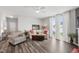 The bright living room offers a ceiling fan, and ample natural light streaming through the sliding glass doors at 321 Everly Mist Way, Wake Forest, NC 27587