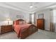 The primary bedroom offers ceiling fan, en-suite bathroom, and warm natural light at 321 Everly Mist Way, Wake Forest, NC 27587