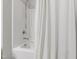 Clean shower space with white tile and curtain, offering a practical and stylish design at 321 Everly Mist Way, Wake Forest, NC 27587