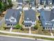An aerial view captures the home's location on a tree-lined street, featuring a well-manicured lawn at 3224 Wishing Well Wynd, Apex, NC 27502
