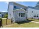 View of backyard featuring black metal fence, green grass and gray vinyl siding at 3224 Wishing Well Wynd, Apex, NC 27502