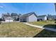A spacious backyard featuring a well-maintained lawn, fenced perimeter, and convenient access to the detached garage at 3224 Wishing Well Wynd, Apex, NC 27502