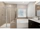Bathroom featuring a glass shower, a soaking tub with a window, and a vanity at 3224 Wishing Well Wynd, Apex, NC 27502
