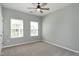 Bedroom featuring neutral carpet, large window, ceiling fan and neutral paint at 3224 Wishing Well Wynd, Apex, NC 27502