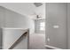 Bonus room at the top of the stairs with neutral paint, carpet and a ceiling fan at 3224 Wishing Well Wynd, Apex, NC 27502