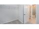 Walk-in closet with carpet and wire shelving; bathroom is visible through doorway at 3224 Wishing Well Wynd, Apex, NC 27502