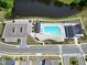 The image displays an outdoor community pool and adjacent recreational area, perfect for relaxation and socializing at 3224 Wishing Well Wynd, Apex, NC 27502
