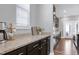 Close-up of a counter with granite countertops and dark cabinets, offering a sleek and functional design at 3224 Wishing Well Wynd, Apex, NC 27502