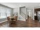 Charming dining area with a wood table, stairwell access, and plenty of natural light at 3224 Wishing Well Wynd, Apex, NC 27502