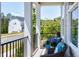 Cozy front porch featuring comfortable seating with blue cushions and a neighborhood view at 3224 Wishing Well Wynd, Apex, NC 27502
