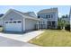 The property features a detached two-car garage with an adjacent backyard, complemented by a private driveway at 3224 Wishing Well Wynd, Apex, NC 27502